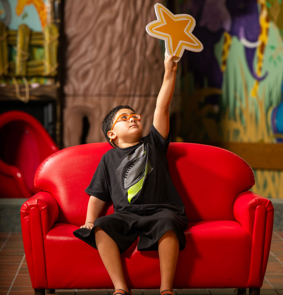 Boy holding star in air