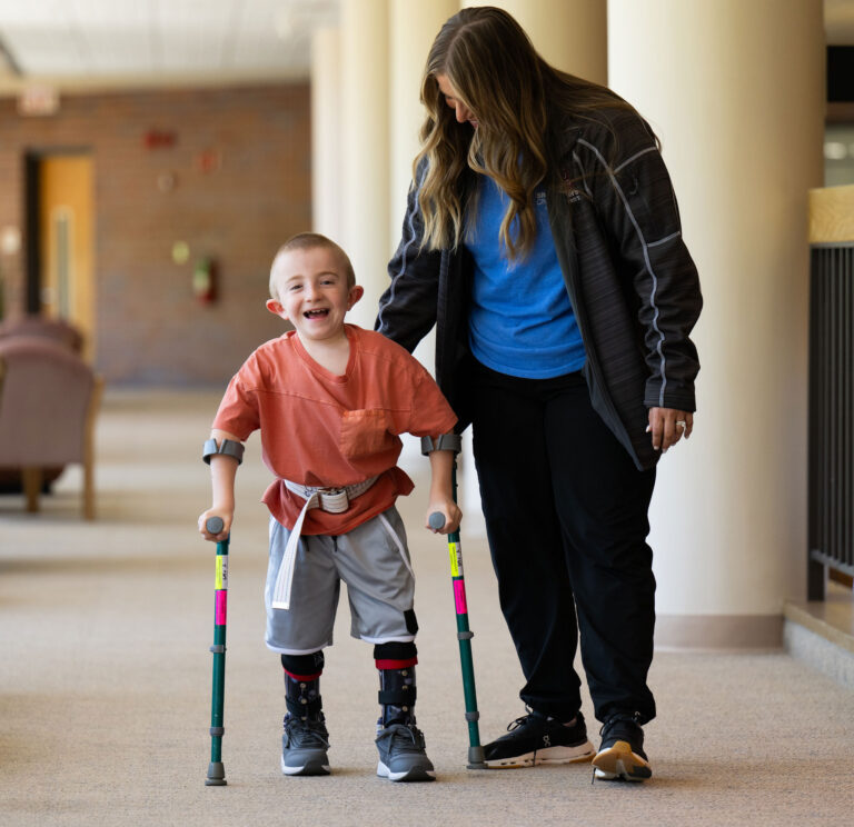 Boy with crutches walking